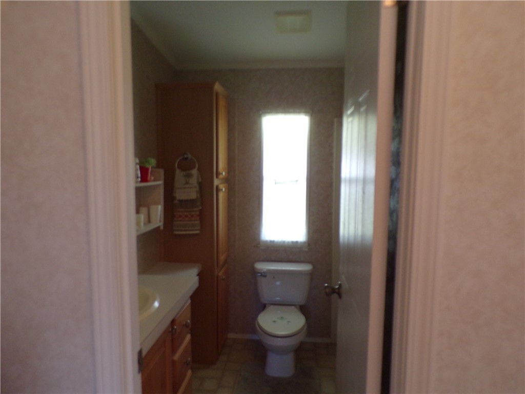 1126 Barefoot Circle Barefoot Bay, FL 32976 - Photo 13 of 16 a bathroom with a toilet and a sink