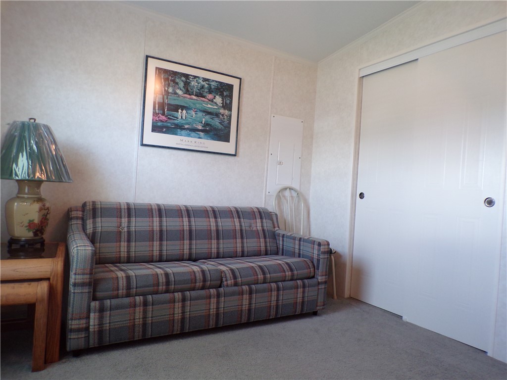 1126 Barefoot Circle Barefoot Bay, FL 32976 - Photo 15 of 16 a bedroom with a bed and a window