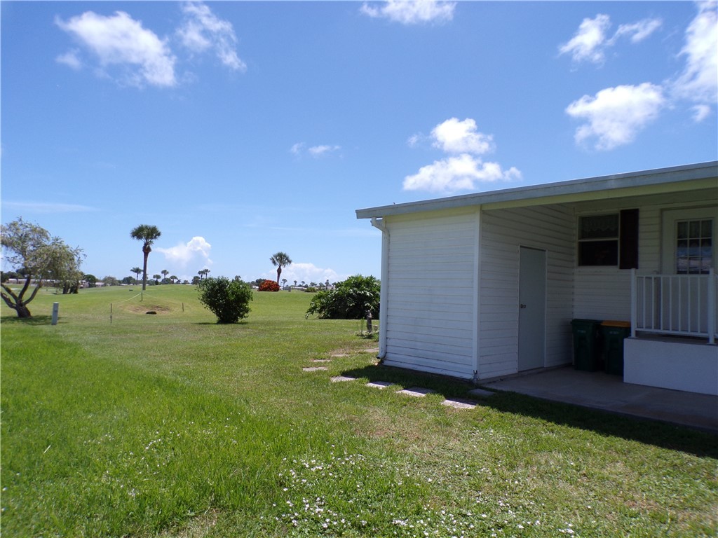 1126 Barefoot Circle Barefoot Bay, FL 32976 - Photo 2 of 16 a view of backyard and entertaining space
