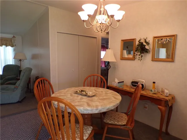 a view of a dining room with furniture and chandelier
