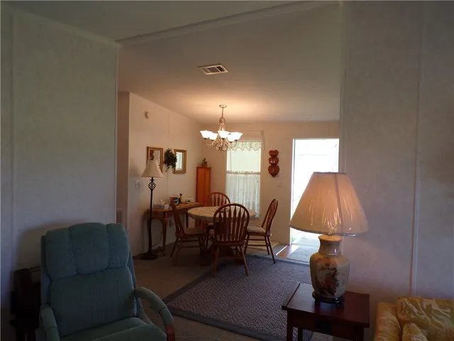 a living room with furniture and a lamp