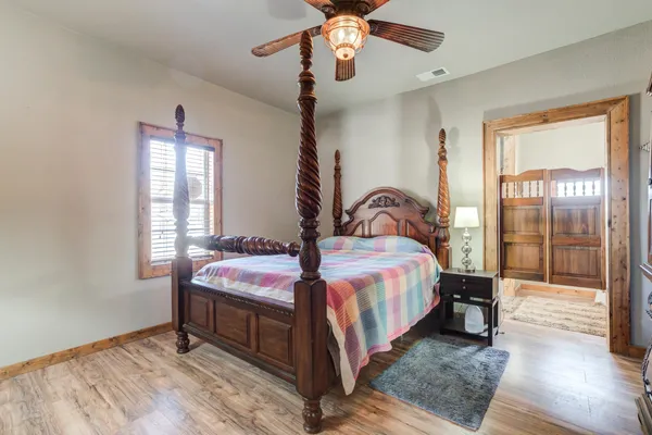 a bedroom with a bed and a chandelier