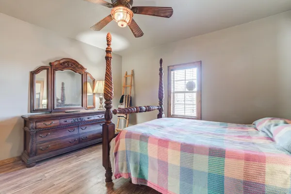 a bedroom with a bed and a chandelier