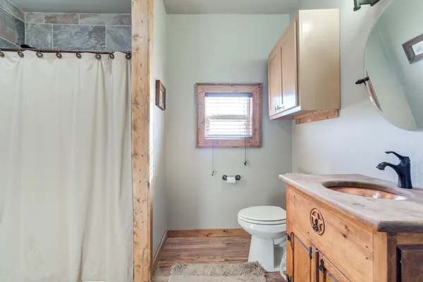 a bathroom with a sink a toilet and a mirror
