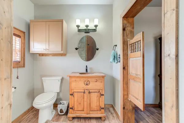 a bathroom with a toilet a sink and mirror