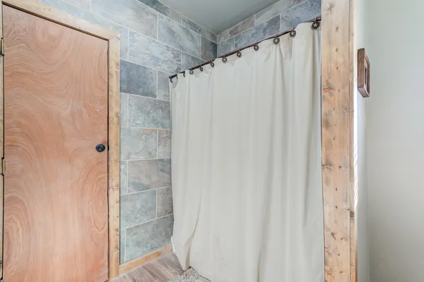 a bathroom with a shower and a glass door