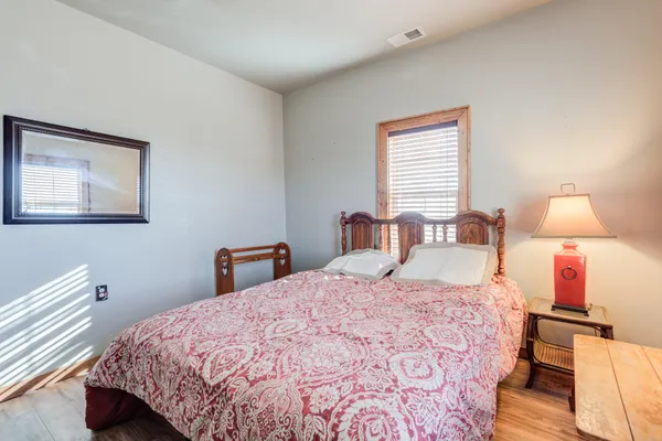 a bedroom with a bed and a lamp on table