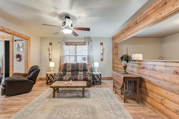a living room with furniture and wooden floor