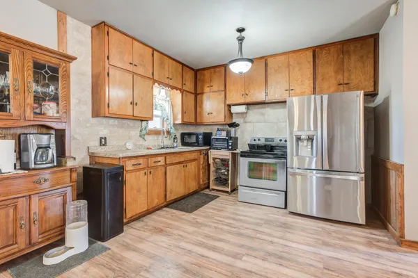 a kitchen with a refrigerator stove top oven and sink