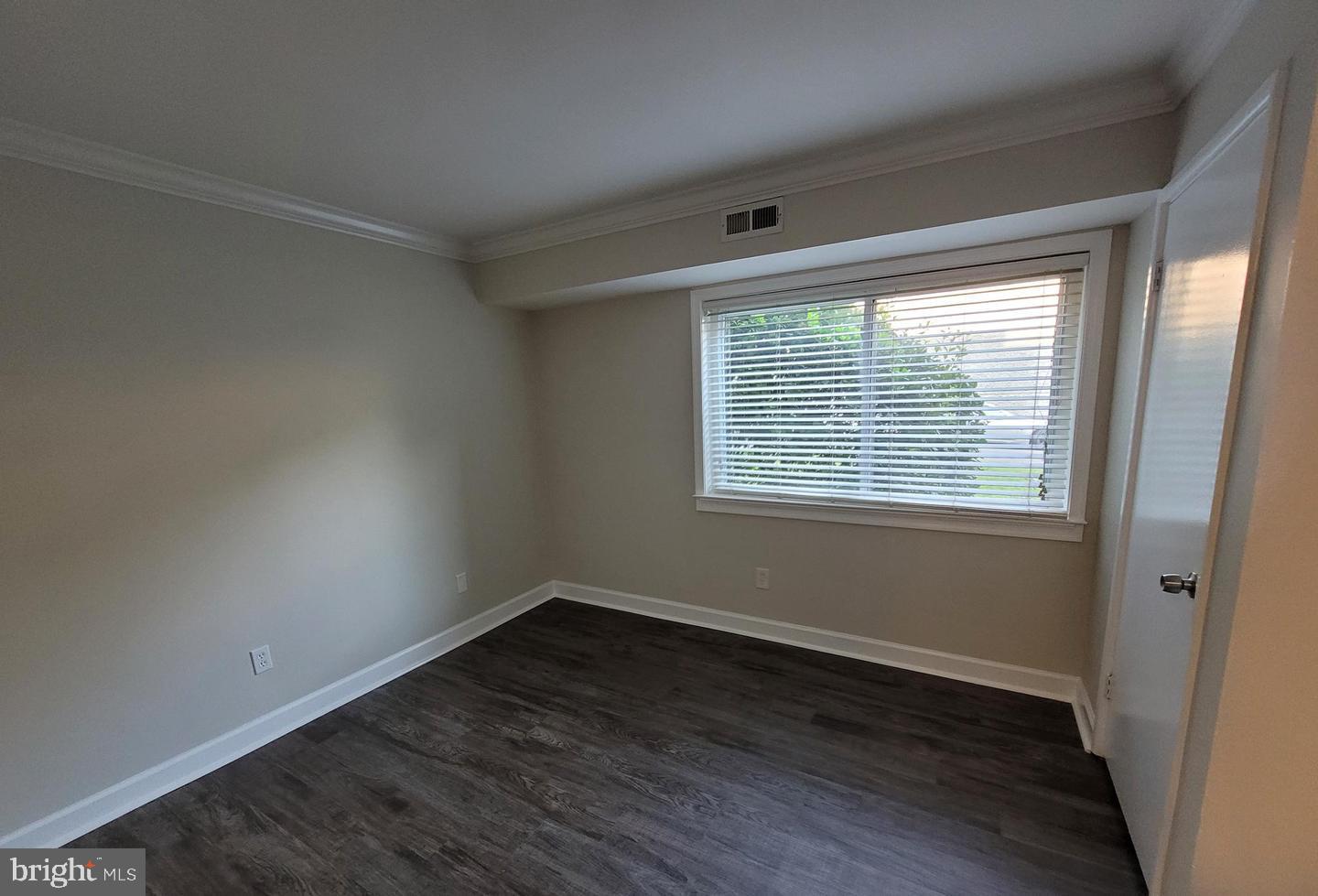 8002 Chanute Place, Unit 3 Falls Church, VA 22042 - Photo 13 of 19 a view of an empty room with wooden floor and a window