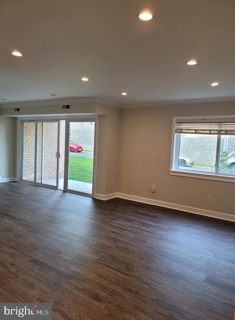 8002 Chanute Place, Unit 3 Falls Church, VA 22042 - Photo 14 of 19 an empty room with wooden floor and windows