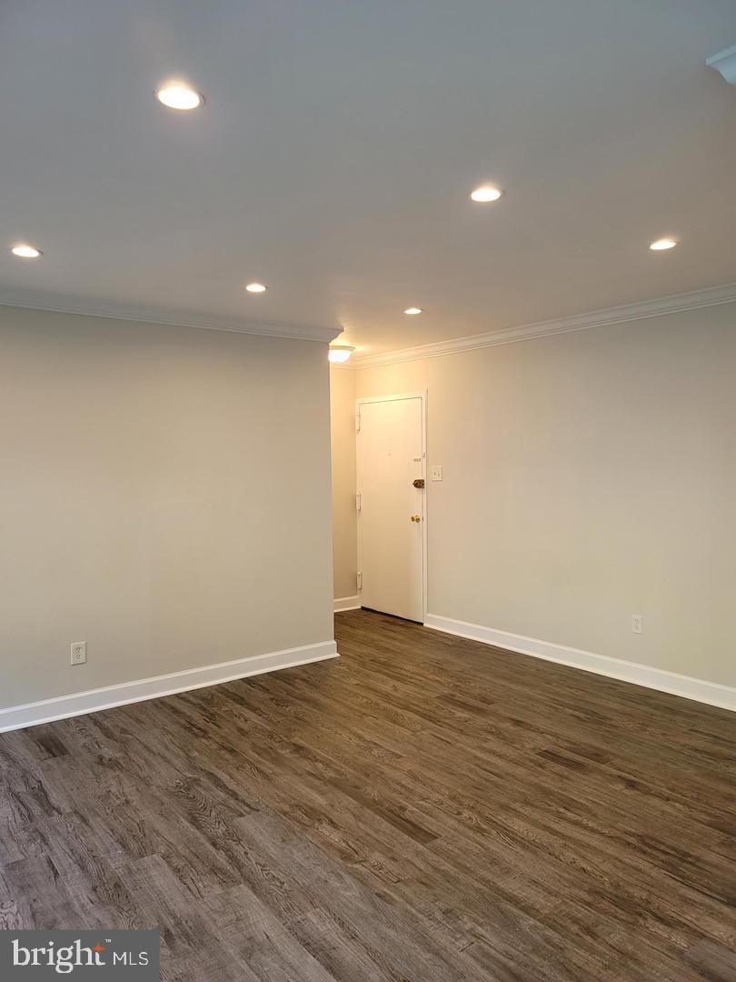 8002 Chanute Place, Unit 3 Falls Church, VA 22042 - Photo 2 of 19 an empty room with wooden floor and windows