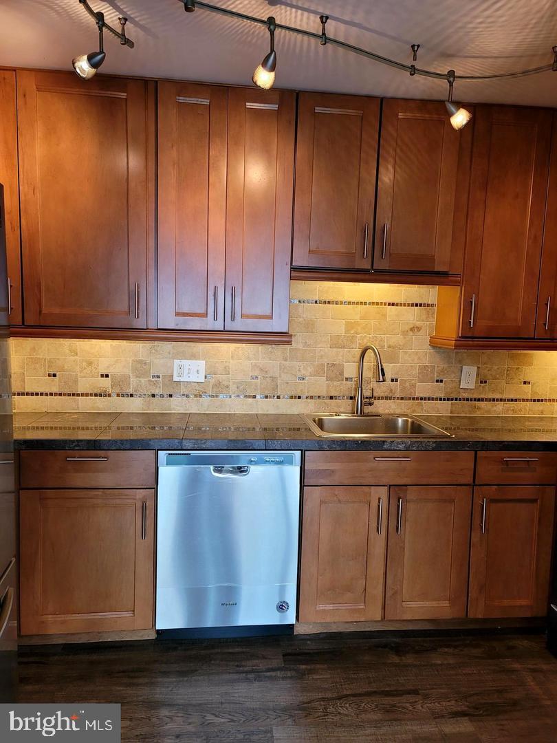 8002 Chanute Place, Unit 3 Falls Church, VA 22042 - Photo 3 of 19 a kitchen with granite countertop wooden cabinets a sink and dishwasher