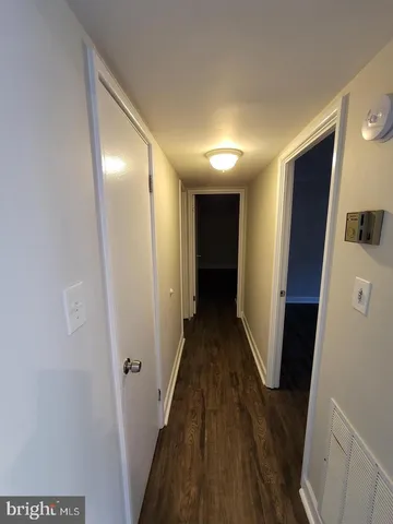 a view of hallway with wooden floor