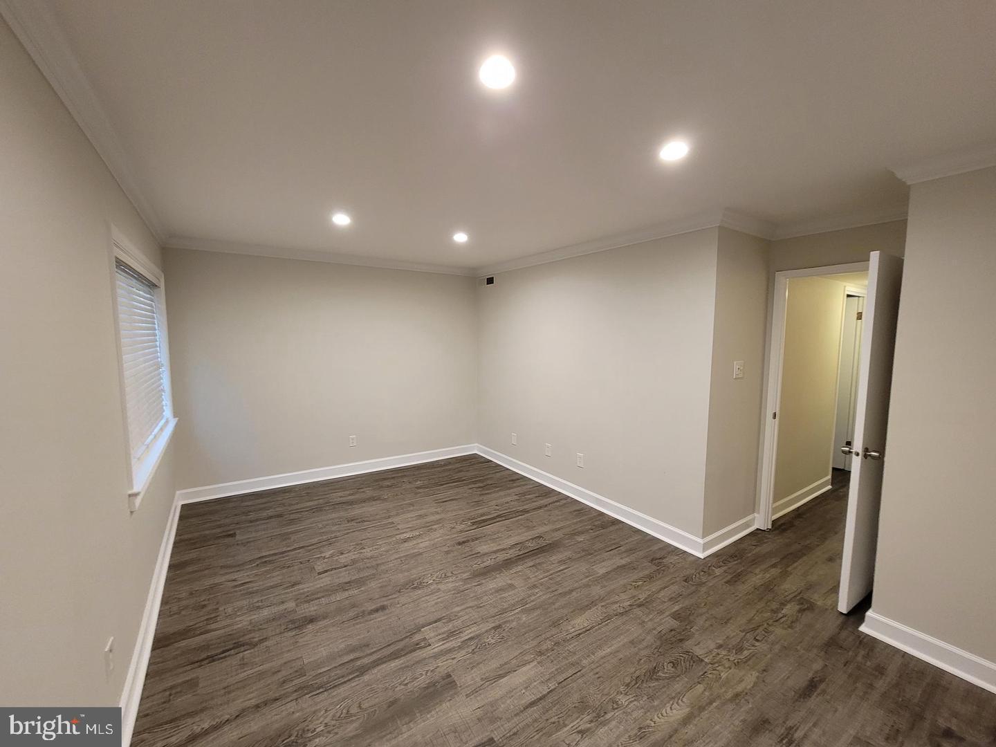 8002 Chanute Place, Unit 3 Falls Church, VA 22042 - Photo 8 of 19 an empty room with wooden floor and windows