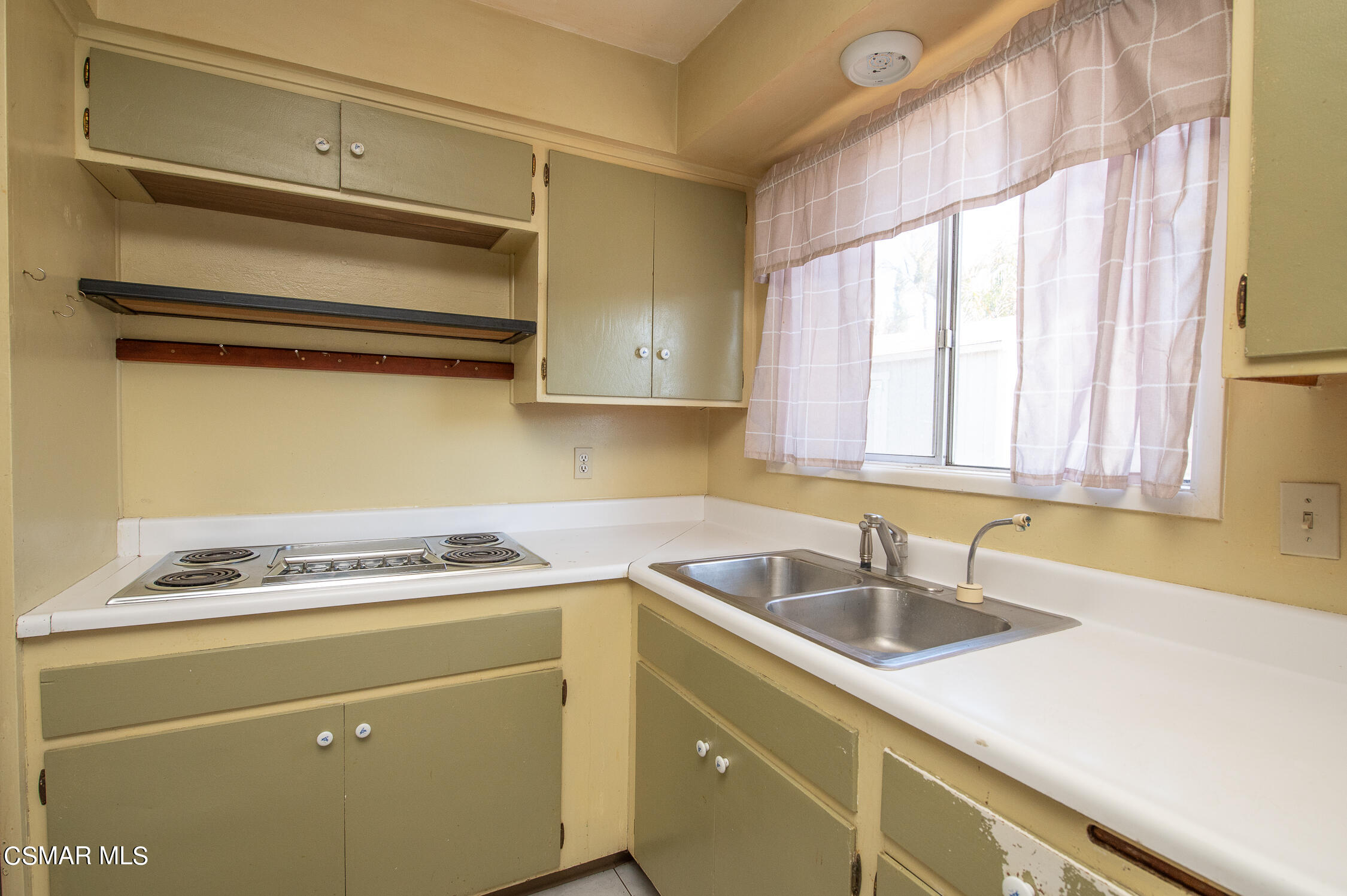 492 Graham Avenue Camarillo, CA 93010 - Photo 13 of 33 a kitchen with a sink cabinets and window