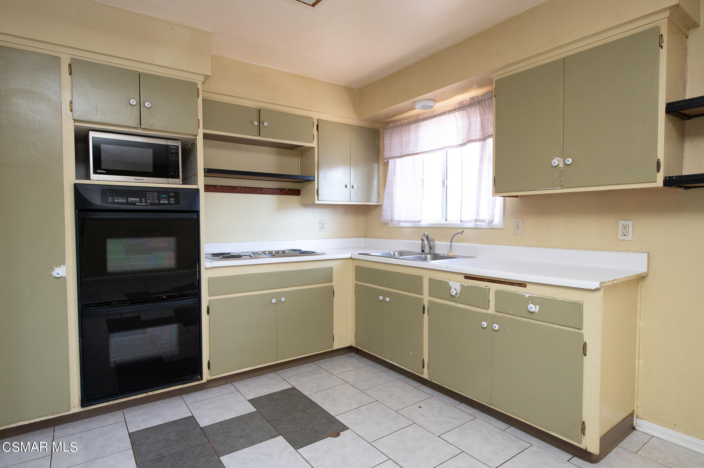 492 Graham Avenue Camarillo, CA 93010 - Photo 9 of 33 a kitchen with a sink stove and microwave