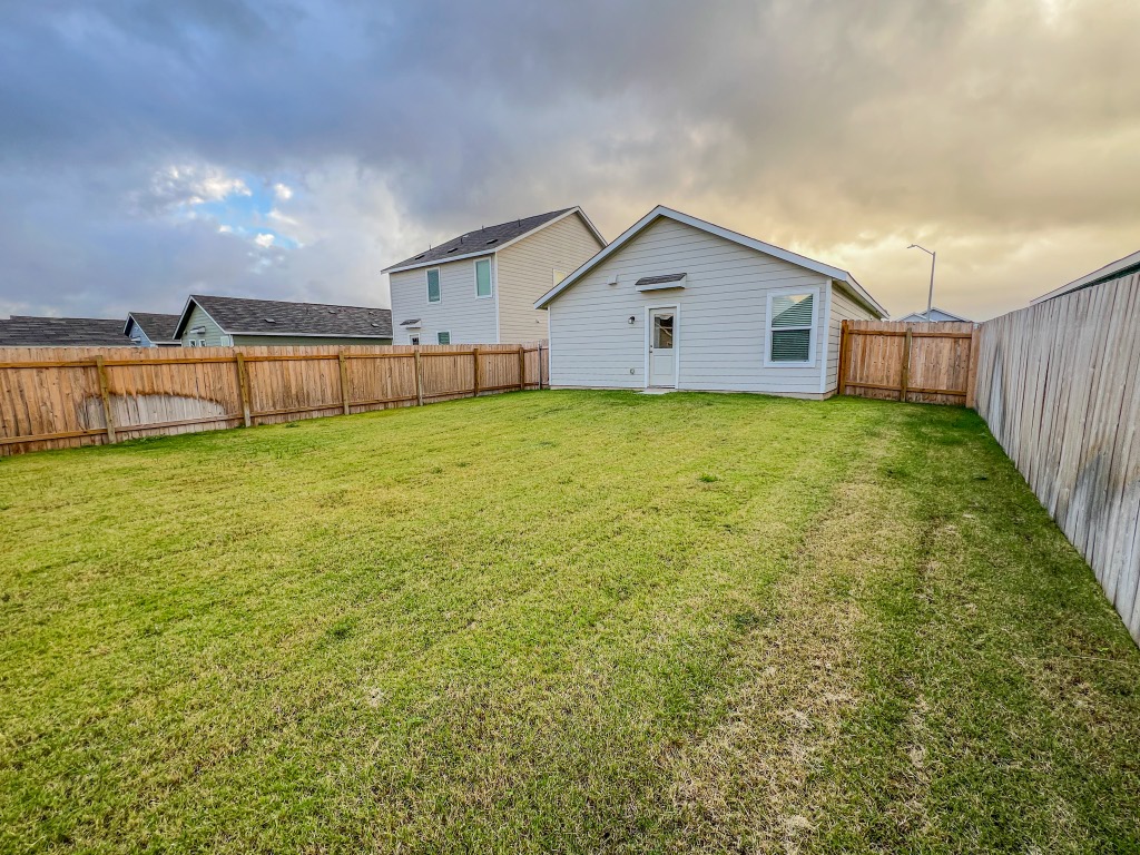 129 Hellcats Way Jarrell, TX 76537 - Photo 18 of 19 Rear view of property with a fenced backyard