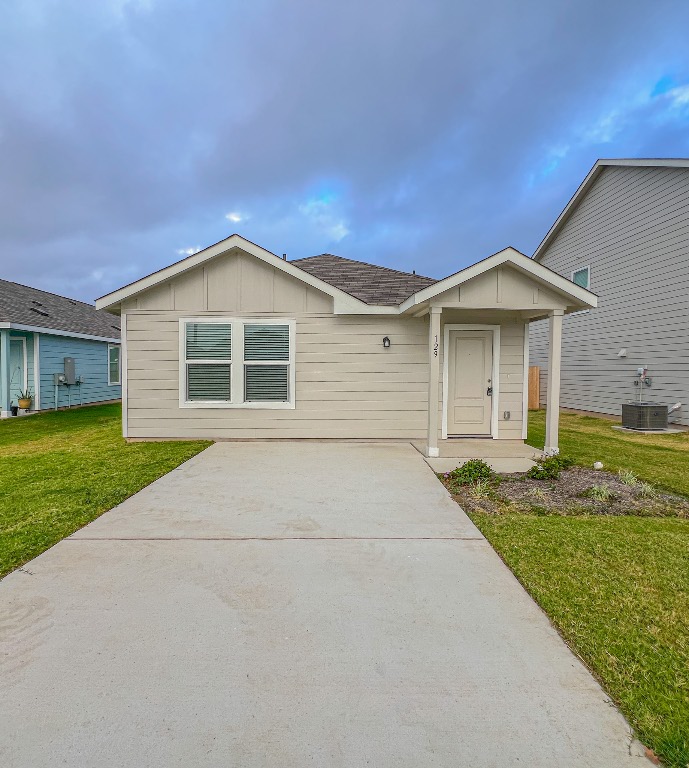 129 Hellcats Way Jarrell, TX 76537 - Photo 2 of 19 View of front of home with board and batten siding, a front lawn, and roof with shingles