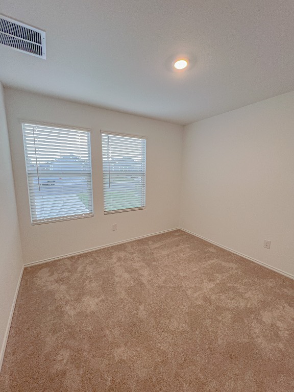 129 Hellcats Way Jarrell, TX 76537 - Photo 6 of 19 Empty room with light carpet and baseboards