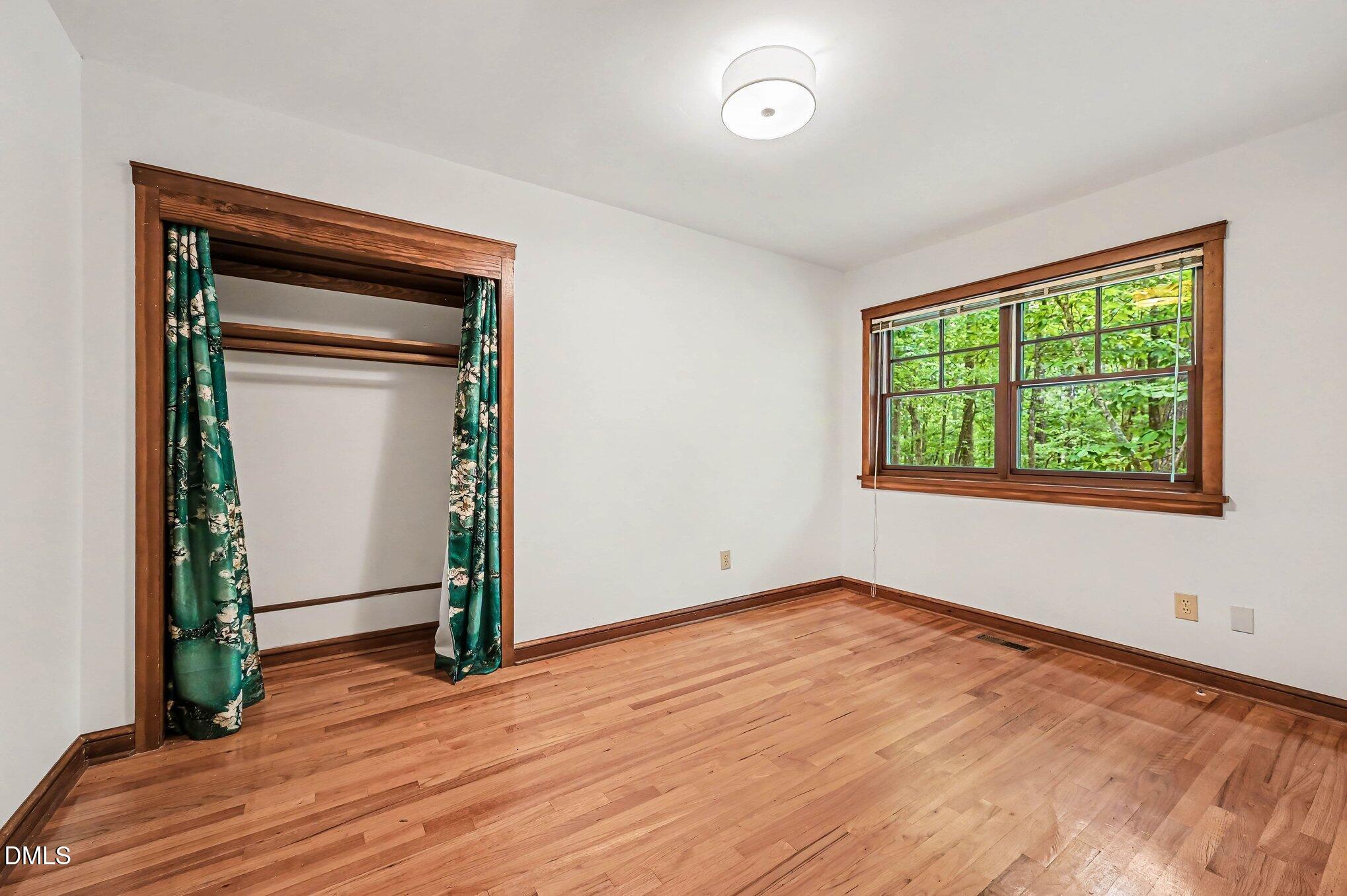 200 Spring Valley Road Carrboro, NC 27510 - Photo 21 of 38 a view of empty room with wooden floor and fan
