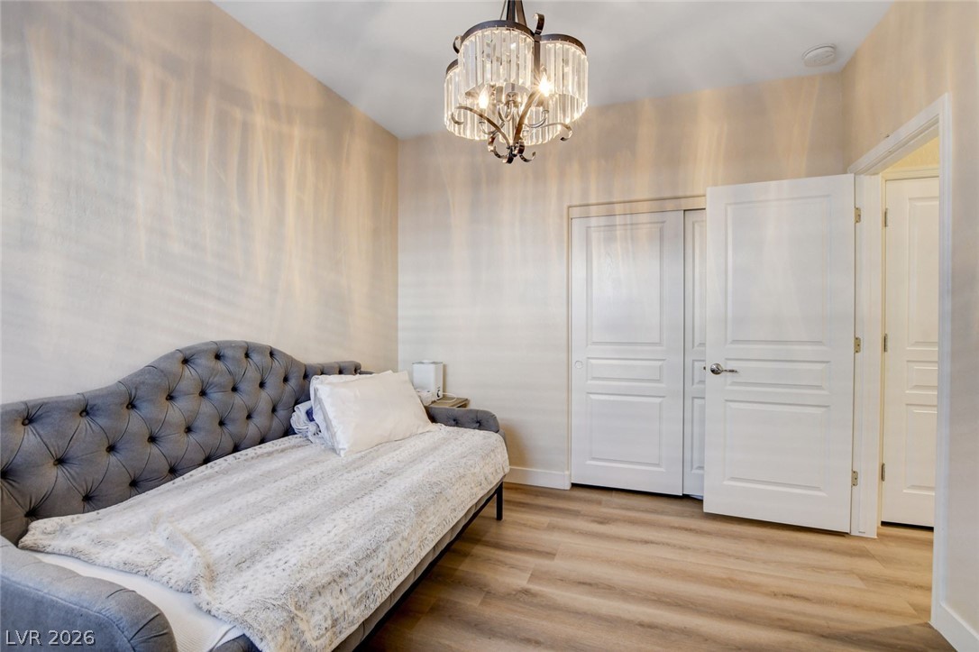 2649 Rue Marquette Avenue Henderson, NV 89044 - Photo 37 of 55 This cozy bedroom offers versatile living space with durable laminate flooring and a distinctive overhead light fixture.