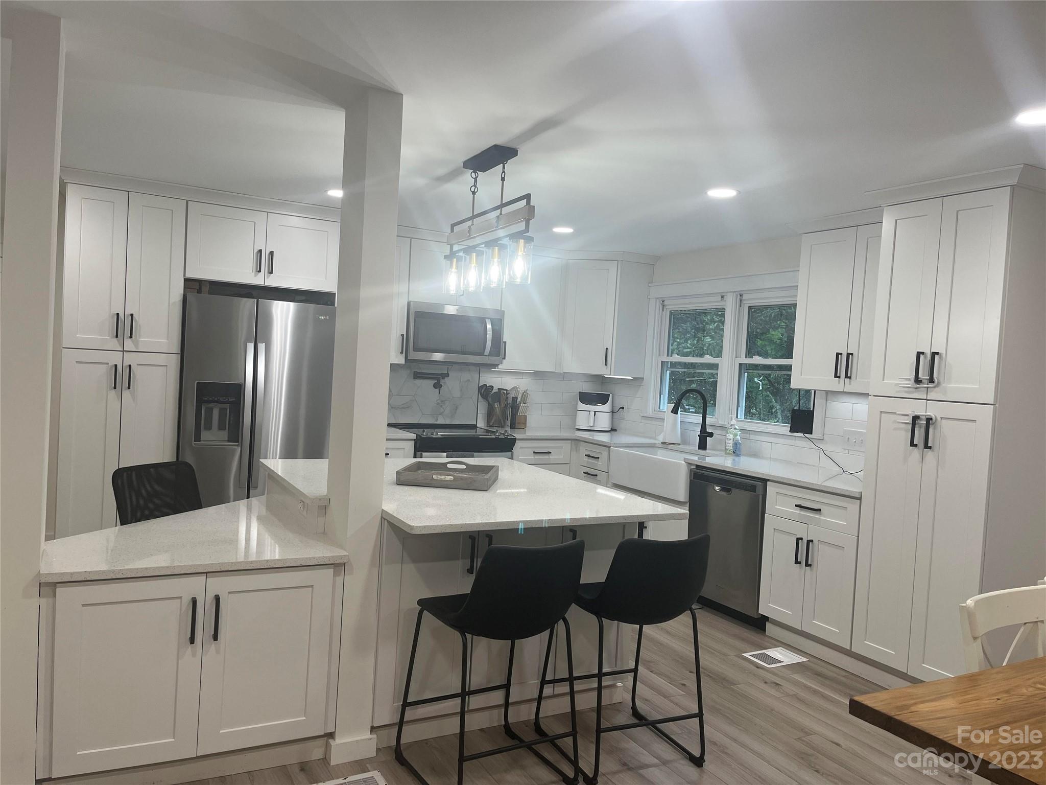 4250 Edgeland Road Edgemoor, SC 29712 - Photo 2 of 8 a kitchen with white cabinets and stainless steel appliances