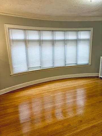 a view of a room with wooden floor and cabinet