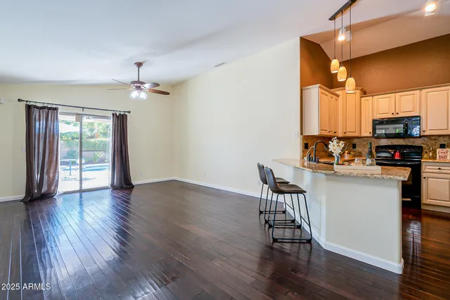a view of a livingroom with furniture wooden floor and a chandelier