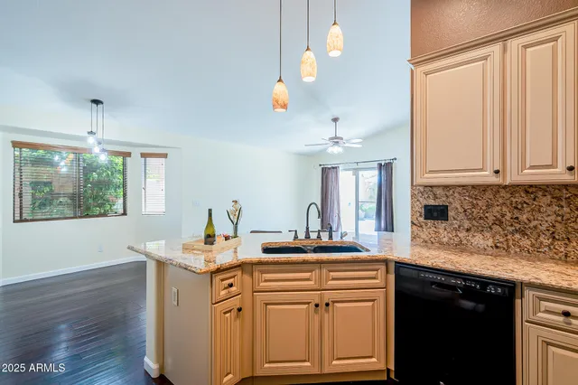 a kitchen with stainless steel appliances kitchen island granite countertop a sink and cabinets