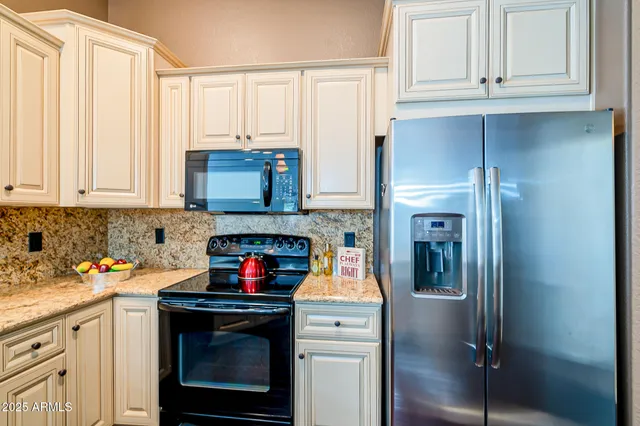 a kitchen with stainless steel appliances granite countertop a sink dishwasher and a stove with wooden floor