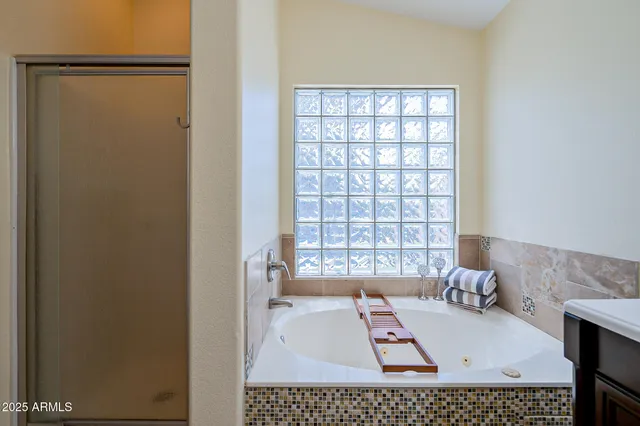 a bathroom with a bathtub and a window