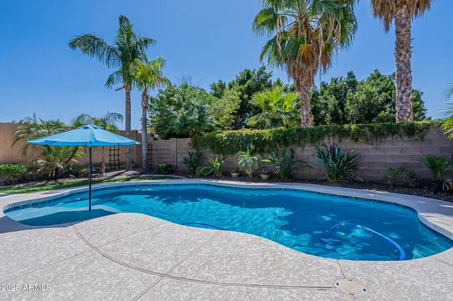 a view of a swimming pool and a yard