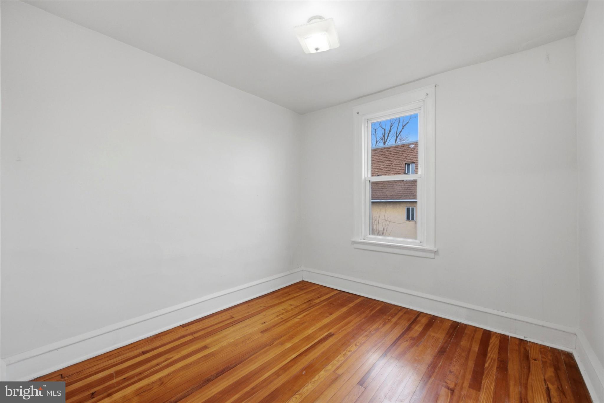 7 Rhodes Avenue Collingdale, PA 19023 - Photo 11 of 27 an empty room with wooden floor and windows