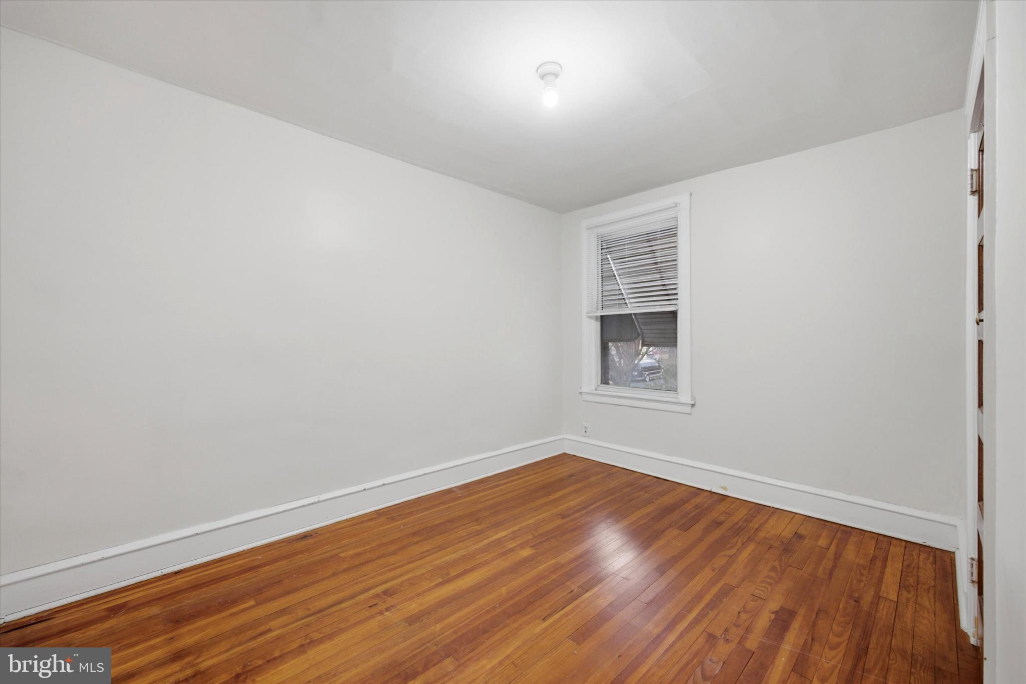 7 Rhodes Avenue Collingdale, PA 19023 - Photo 17 of 27 a view of an empty room with wooden floor and a window