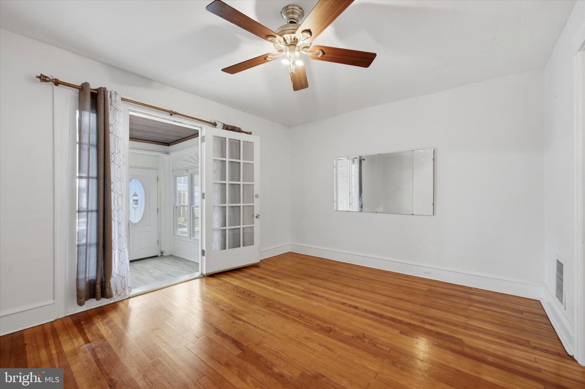 7 Rhodes Avenue Collingdale, PA 19023 - Photo 3 of 27 a view of empty room with wooden floor and fan