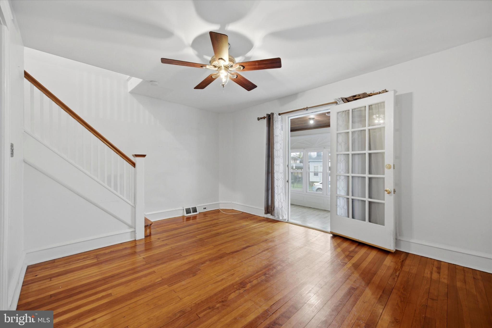 7 Rhodes Avenue Collingdale, PA 19023 - Photo 4 of 27 a view of empty room with wooden floor and fan