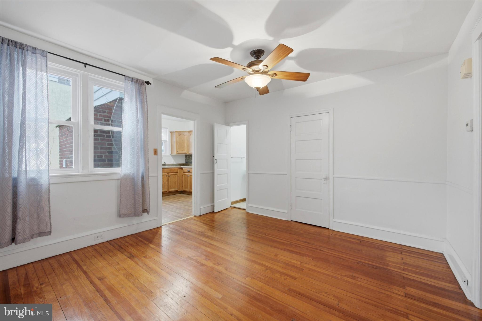 7 Rhodes Avenue Collingdale, PA 19023 - Photo 7 of 27 a view of an empty room with wooden floor and a window