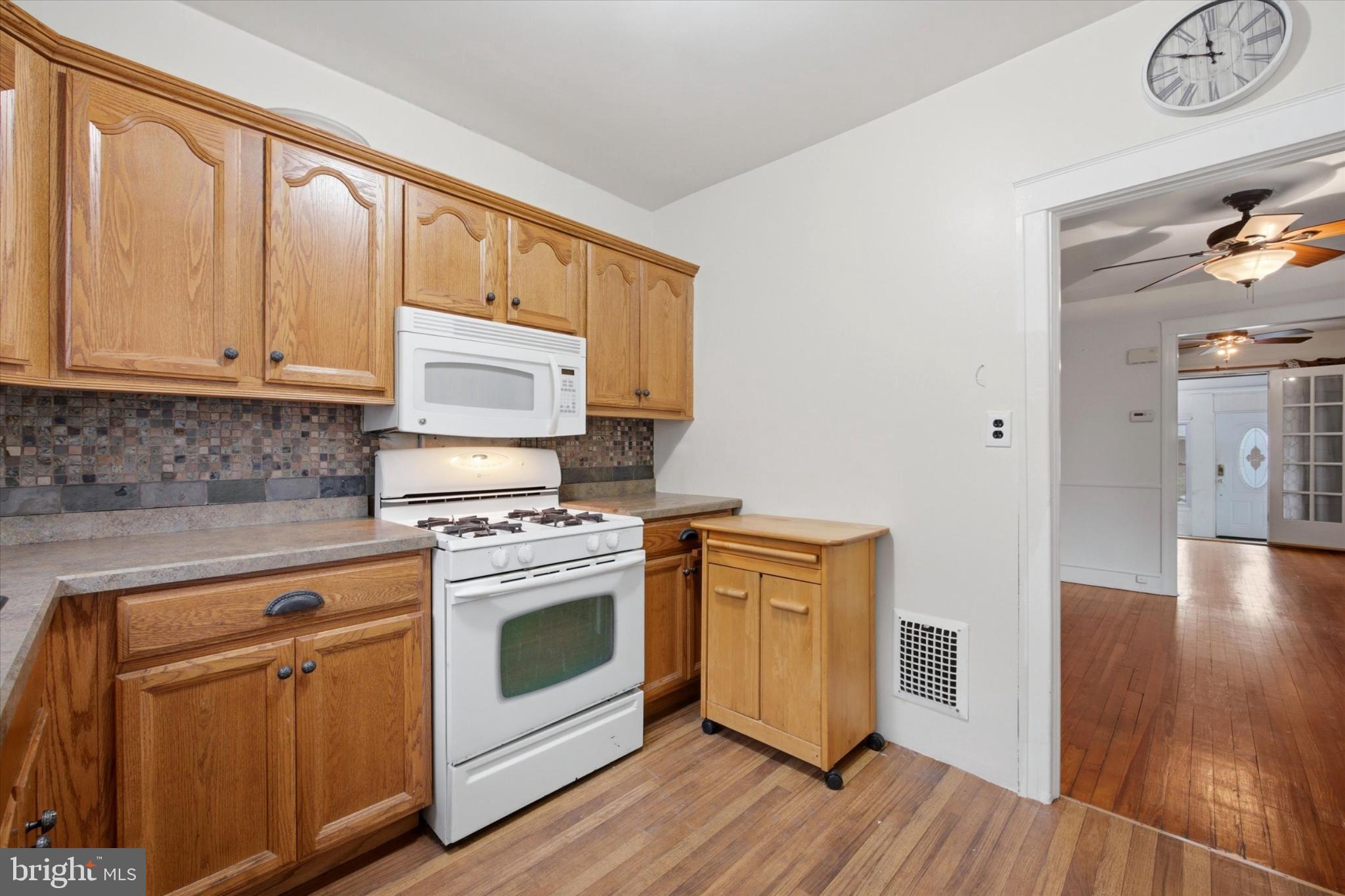 7 Rhodes Avenue Collingdale, PA 19023 - Photo 9 of 27 a kitchen with stainless steel appliances granite countertop a stove a sink and a microwave