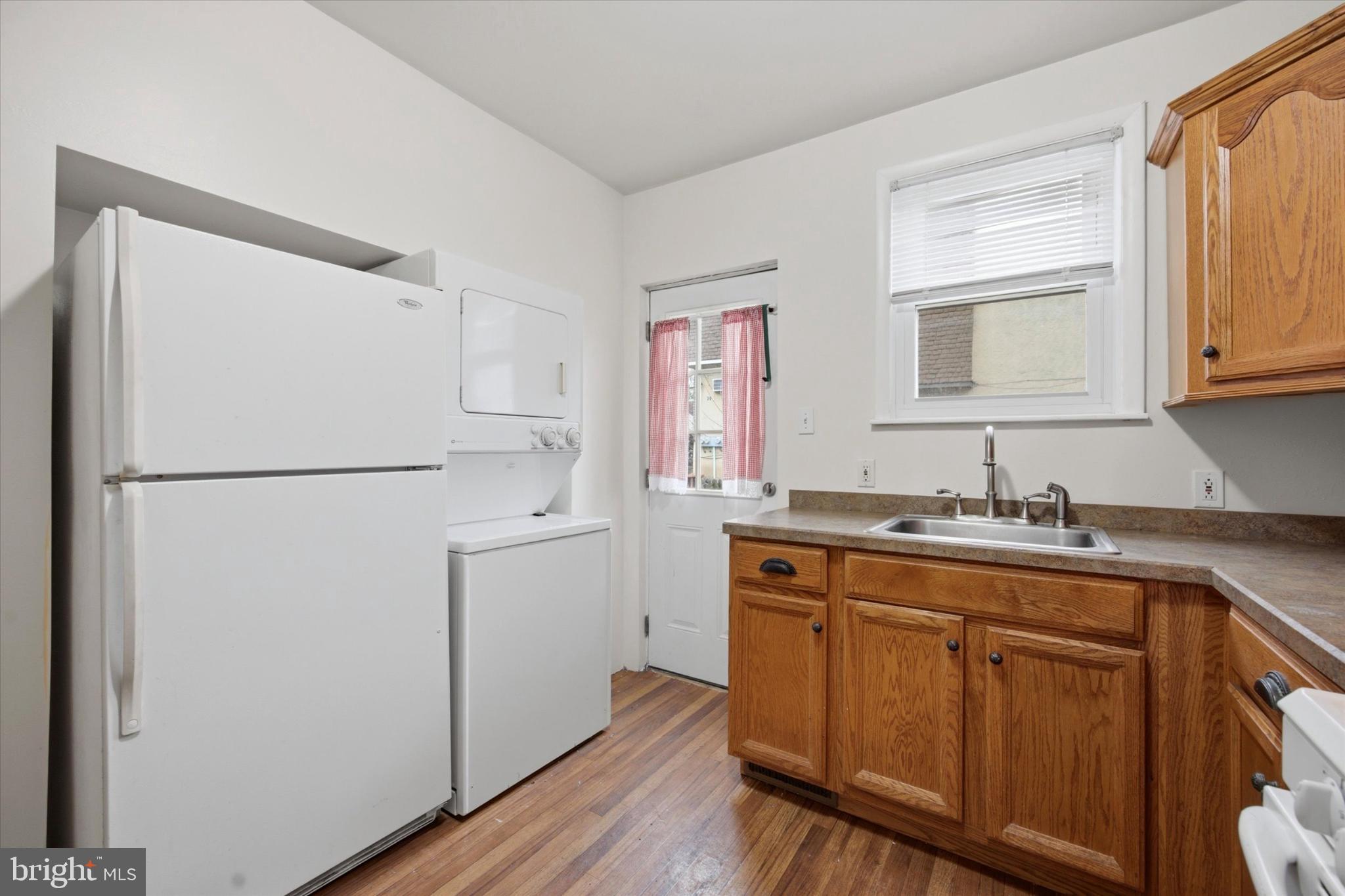 7 Rhodes Avenue Collingdale, PA 19023 - Photo 10 of 27 a kitchen with sink refrigerator and cabinets