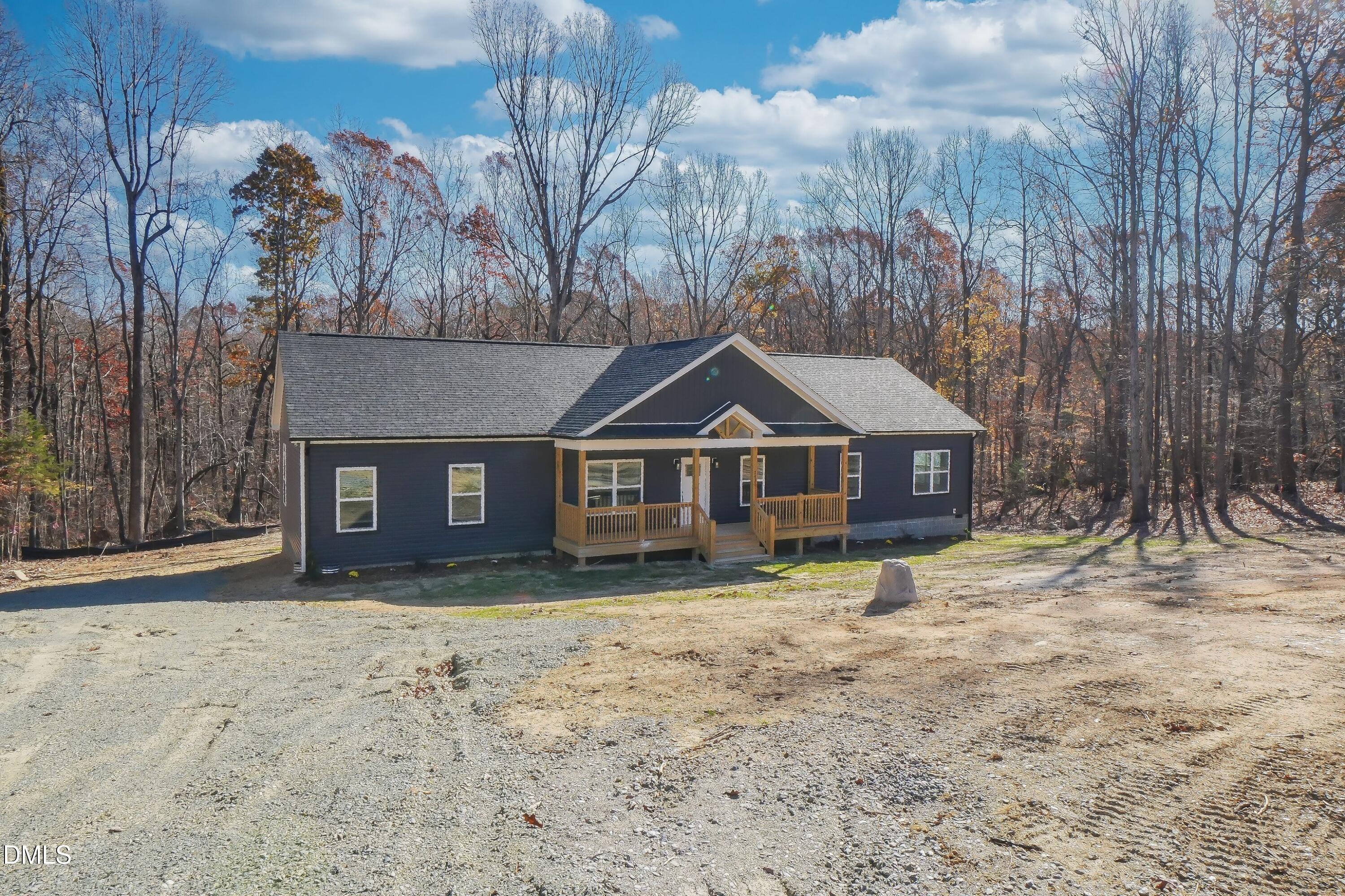 5430 Bass Mountain Road Snow Camp, NC 27349 - Photo 2 of 14 a front view of a house with a yard and garage