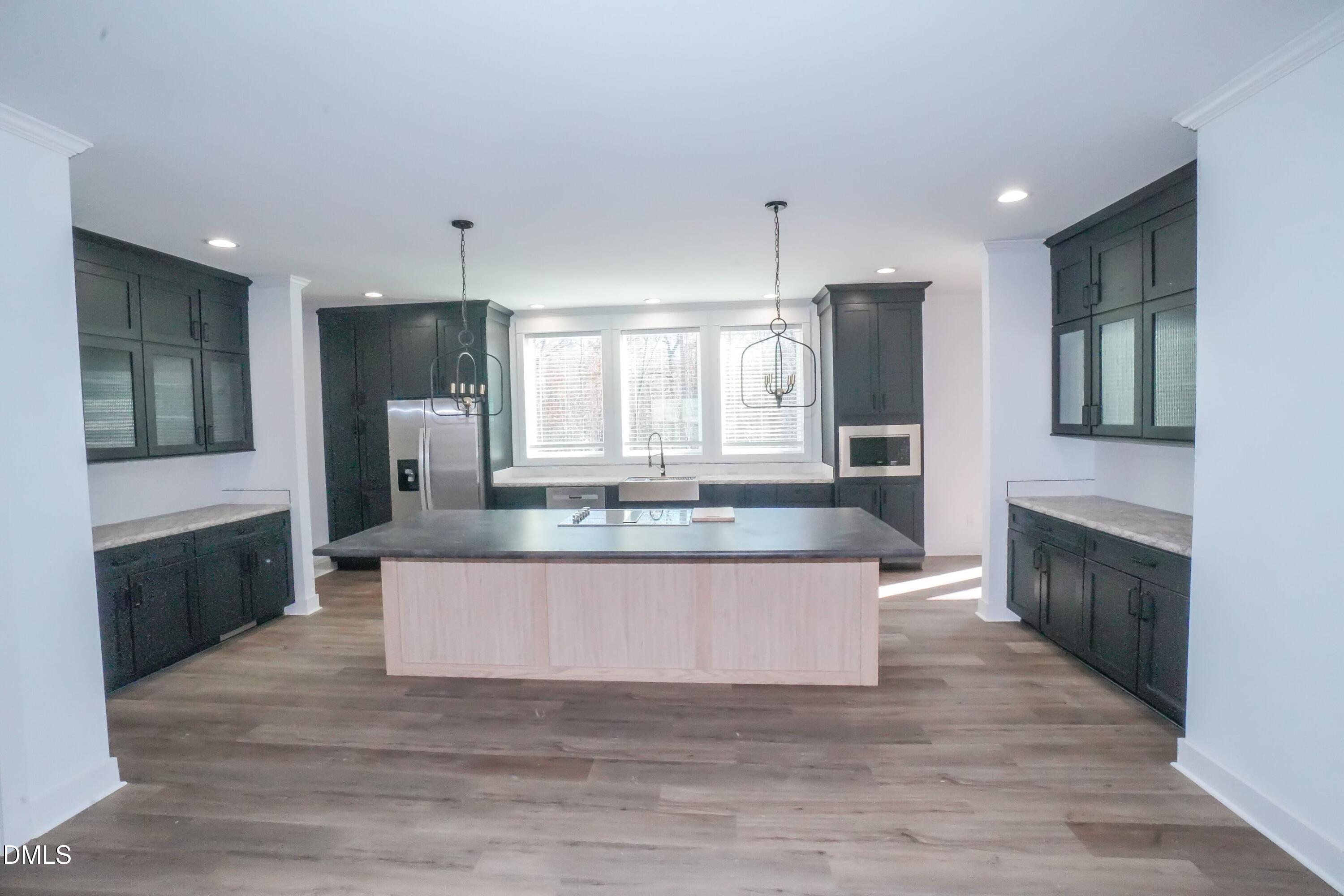 5430 Bass Mountain Road Snow Camp, NC 27349 - Photo 5 of 14 a kitchen with stainless steel appliances granite countertop a stove a sink and a refrigerator