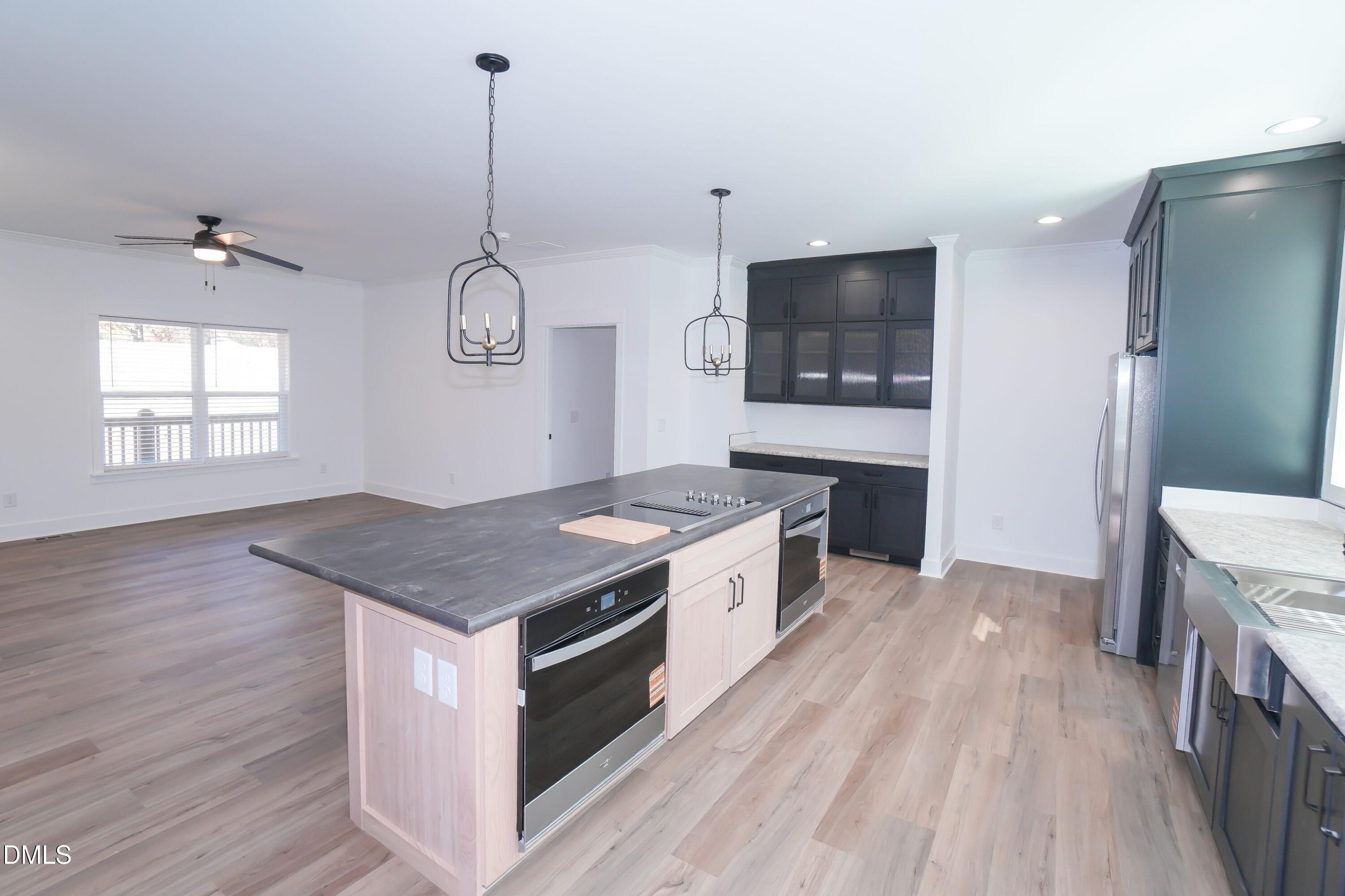 5430 Bass Mountain Road Snow Camp, NC 27349 - Photo 6 of 14 a kitchen with a stove and a wooden floor