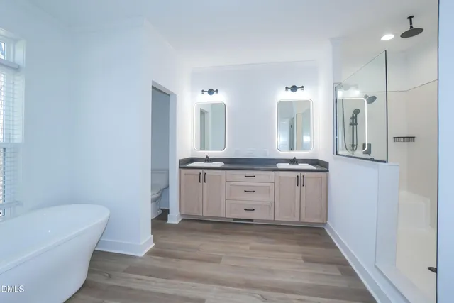 a bathroom with a granite countertop sink mirror and bathtub