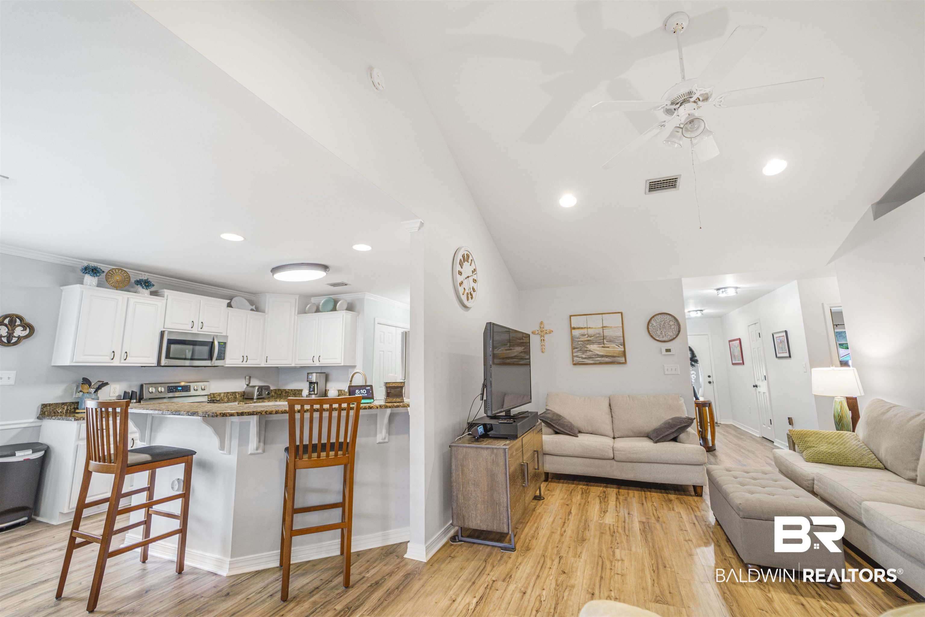 4620 Pine Boulevard Orange Beach, AL 36561 - Photo 10 of 49 Living area featuring vaulted ceiling, a ceiling fan, light wood-style floors, and recessed lighting
