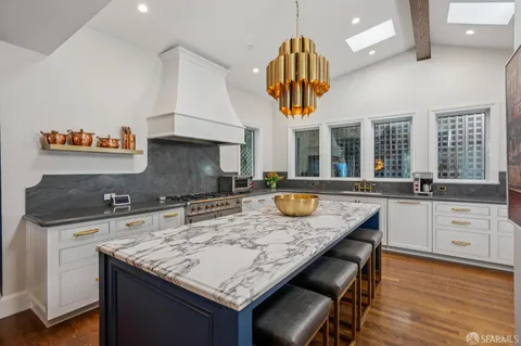 a kitchen with a sink a counter space and stainless steel appliances