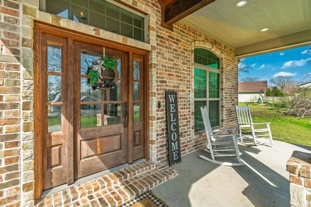 a porch with a table and chairs