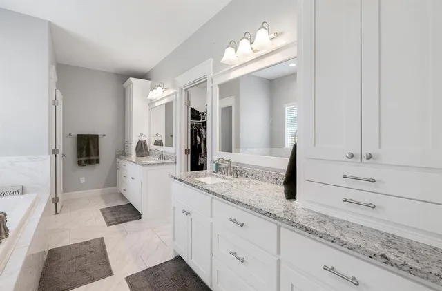 a bathroom with a bathtub and a shower