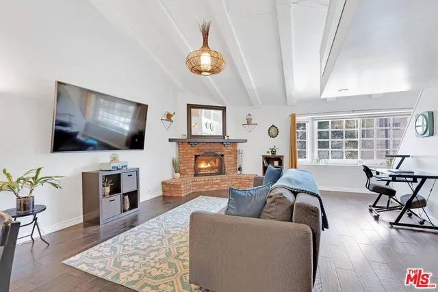 a living room with fireplace furniture and a flat screen tv
