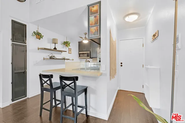 a dining room with furniture and wooden floor